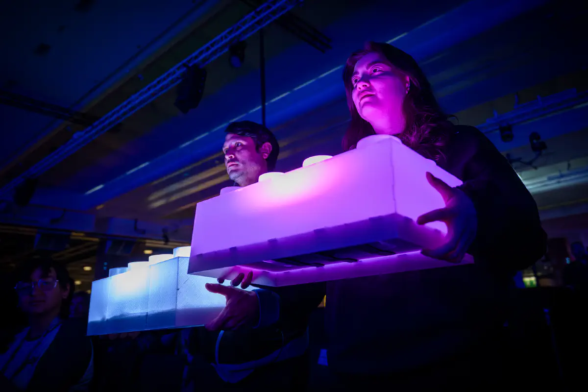 glowing bricks held by iGEM staff